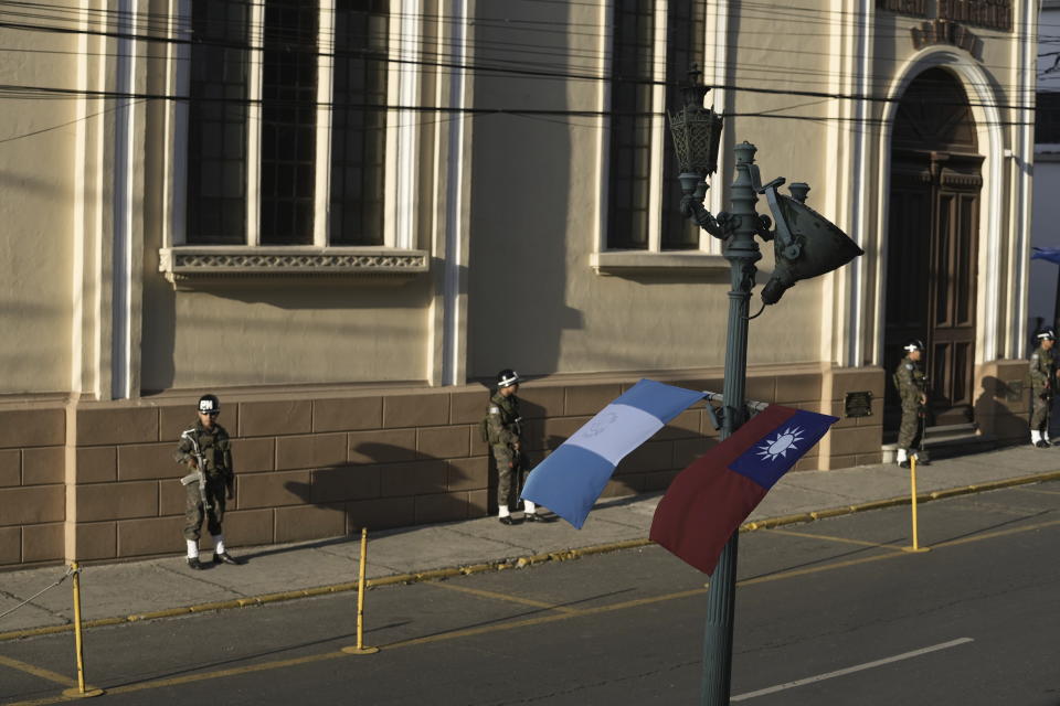 National flags representing Guatemala and Taiwan are posted on a light pole as security forces guard the perimeters of the National Palace in preparation for the arrival of Taiwan's President Tsai Ing-wen, in Guatemala City, Friday, March 31, 2023. Tsai is in Guatemala for a three-day official visit. (AP Photo/Moises Castillo)