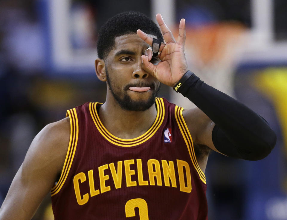 Cleveland Cavaliers guard Kyrie Irving celebrates after making a 3-point basket against the Golden State Warriors during the second half of an NBA basketball game Friday, March 14, 2014, in Oakland, Calif. Cleveland won 103-94. (AP Photo/Marcio Jose Sanchez)