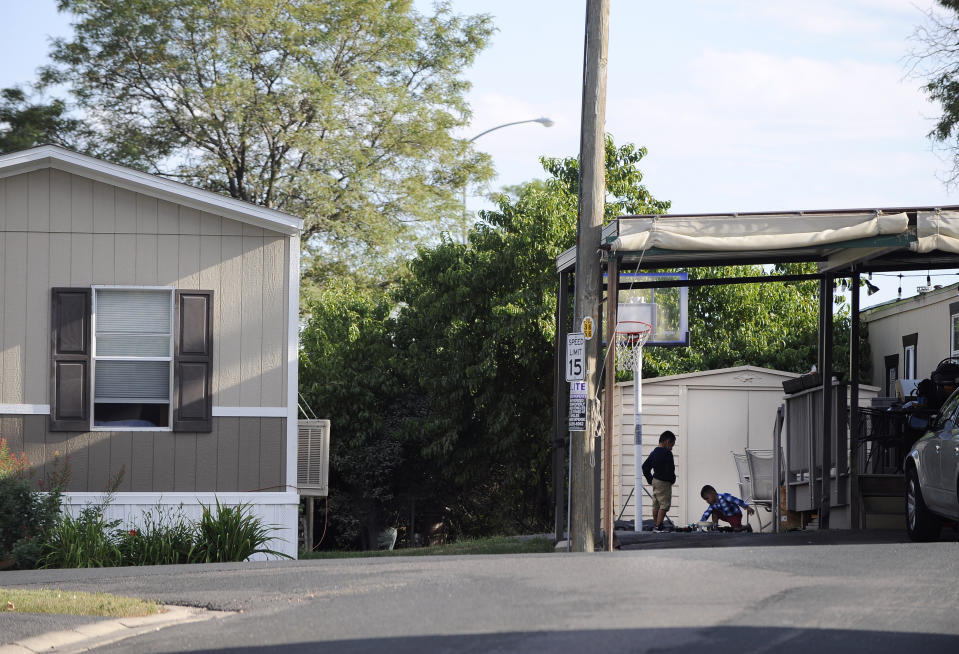 ADVANCE ON THURSDAY, SEPT. 12 FOR USE ANY TIME AFTER 3:01 A.M. SUNDAY SEPT 15 - In this Aug. 30th 2019 photo shows residents of Lamplighter Village, a manufactured and mobile home park, spending time outdoors in their community in Federal Heights, Colo. Across Colorado, where the housing crisis impacts both rural and urban towns, the strife between mobile home park residents and park owners approaches a boiling point. The business model -- in which homeowners pay lot rent to park their houses on someone else's land -- capitalizes on the immobility and economic fragility of tenants who often can't afford to move or live anywhere else.(Kathryn Scott/The Colorado Sun)