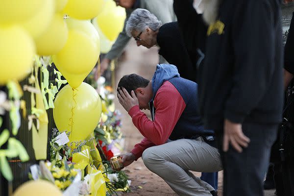 Stephanie's fiance breaks down at a memorial site outside Leeton High School. Photo: AAP