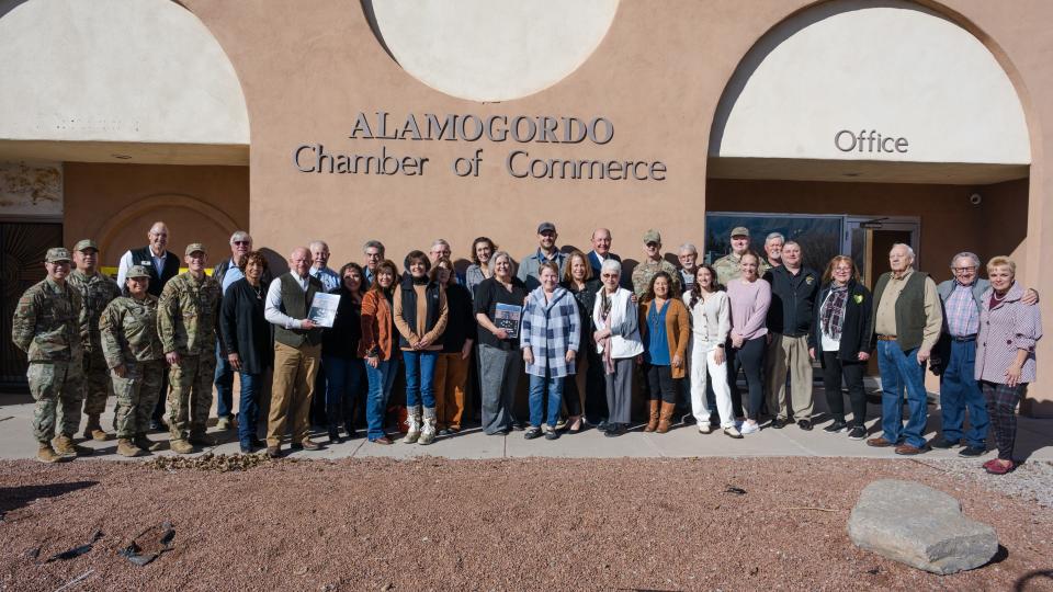 Members of the Alamogordo community and Holloman Air Force Base personnel pose for a group photo celebrating the announcement of winning the 2023 Altus Trophy award at the Alamogordo Chamber of Commerce, New Mexico, Feb. 8, 2024.