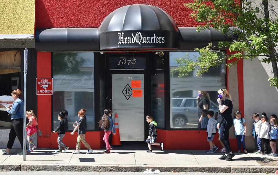 On Wednesday morning, a group of school students walk past the building at 1375 Pleasant St., that is reportedly used as a clubhouse by the Pagans motorcycle club.