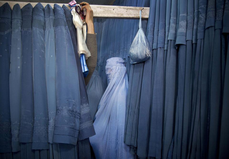 FILE - In this Thursday, April 11, 2013 file photo made by Associated Press photographer Anja Niedringhaus, an Afghan woman waits in a changing room to try out a new Burqa, in a shop at in the old city of Kabul, Afghanistan. Niedringhaus, 48, an internationally acclaimed German photographer, was killed and AP reporter Kathy Gannon was wounded on Friday, April 4, 2014 when an Afghan policeman opened fire while they were sitting in their car in eastern Afghanistan. (AP Photo/Anja Niedringhaus, File)