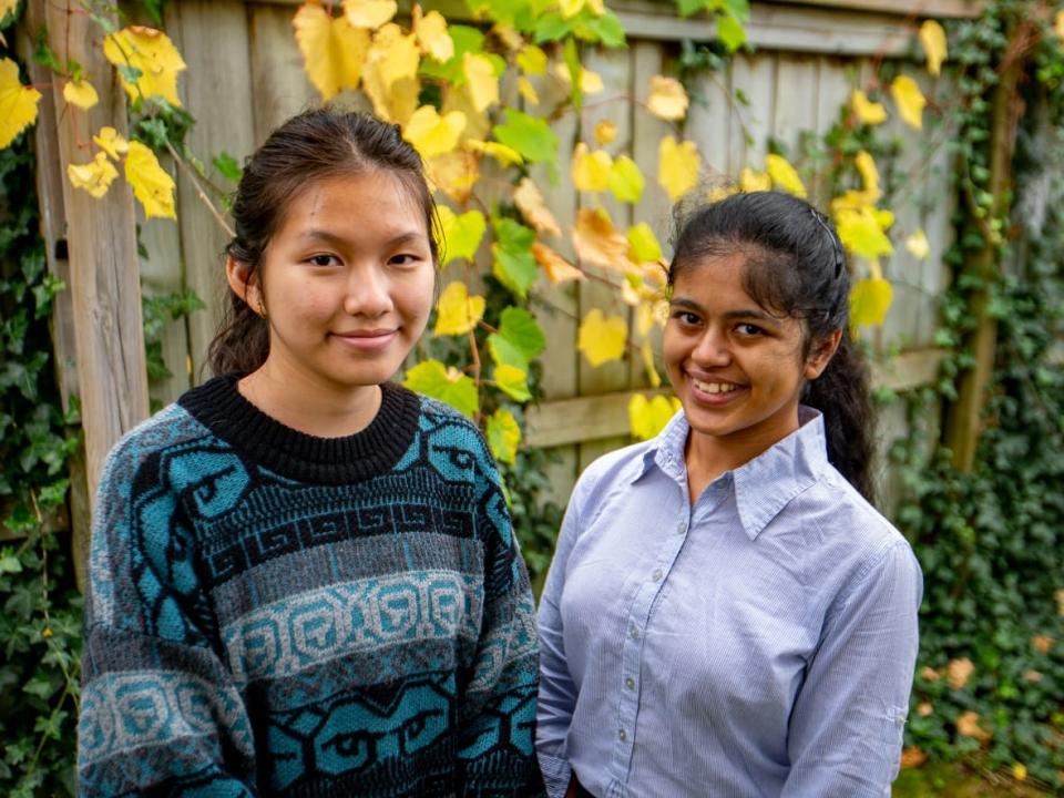 Evelyn Jia, left, and Rachna Venkatesh are two senior high school students in Mississauga, Ont., who are critical of the hybrid system that has one teacher instructing both in-person and remote students simultaneously.  (Craig Chivers/CBC - image credit)