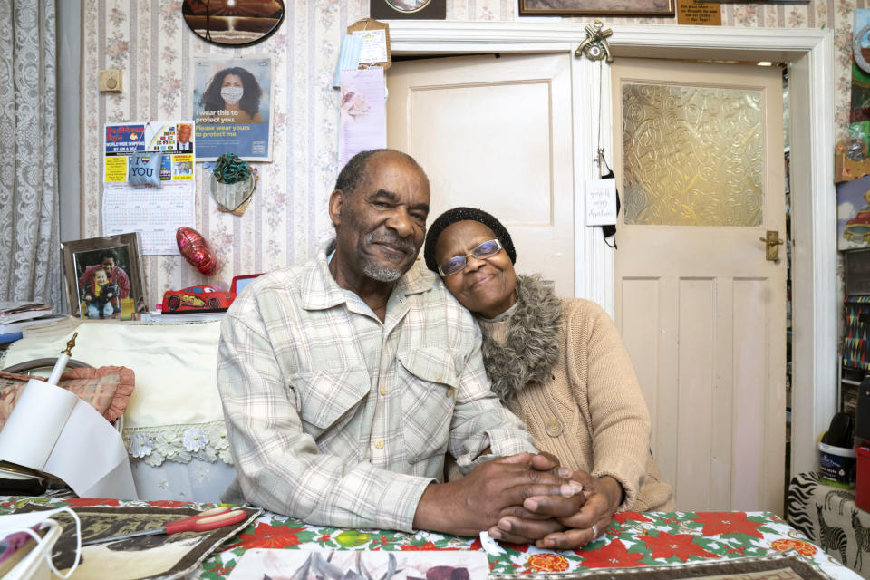 Sylius, left, and Bridgette Toussaint pose for a photo after having meals delivered by members of the Preston Windrush Covid Response team, in Preston, England, Friday Feb. 19, 2021. Once a week chief coordinator Glenda Andrew and her team distribute meals to people in Preston and surrounding communities in northwestern England that have recorded some of the U.K.’s highest coronavirus infection rates. The meal program grew out of Andrew’s work with Preston Windrush Generation & Descendants, a group organized to fight for the rights of early immigrants from the Caribbean and other former British colonies who found themselves threatened with deportation in recent years. (AP Photo/Jon Super)