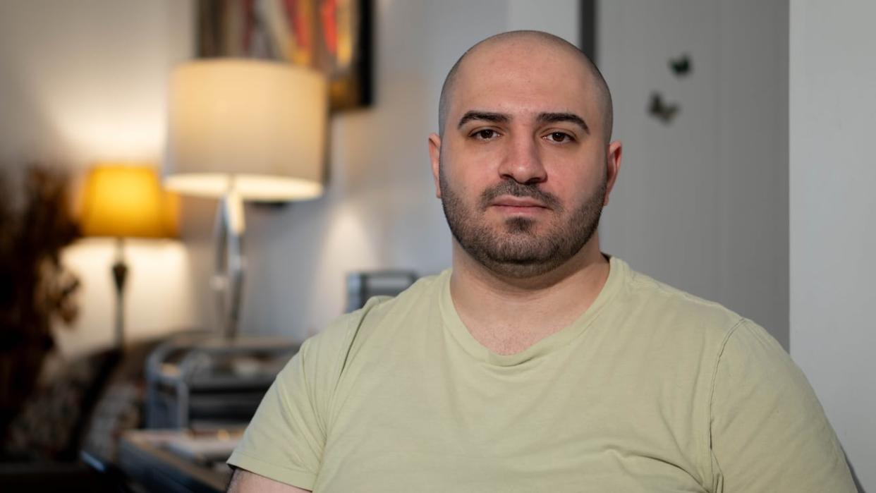 Tisir Otahbachi has been living with itching and burning skin ever since getting vaccinated against COVID-19 in 2021. The 30-year-old Gatineau, Que., man has applied for financial relief under Quebec's vaccine injury support program but continues to wait for a decision. (Jean Delisle/CBC - image credit)