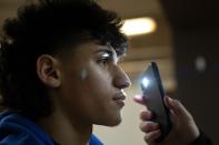Julian David Lugo, 19, who fights at the 139-pound weight class, is checked out by an official doctor on a night of quarter-final boxing matches at the Chicago Golden Gloves tournament Thursday, March 16, 2023, at Cicero Stadium in Cicero, Ill. “It’s important to me because I want to get my name out there,” says Lugo, who started boxing when he was 9. “I want (the boxing community to know) who I am.” (AP Photo/Erin Hooley)
