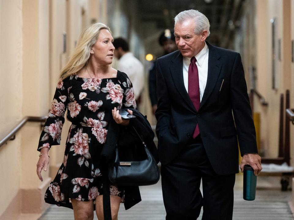 Greene walks with Arizona Rep. David Schweikert, one of the most vulnerable House Republicans at the Capitol on March 28, 2023.