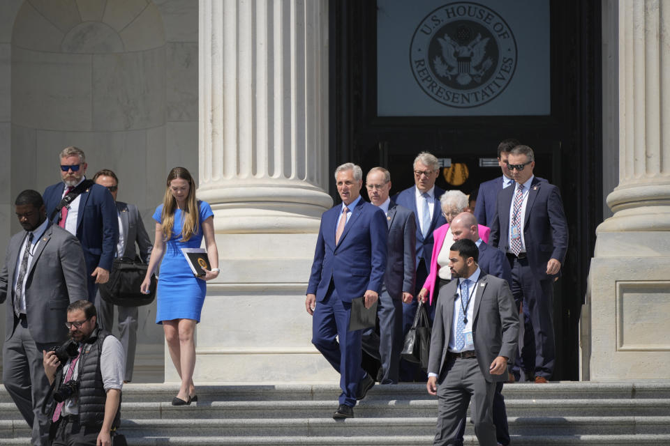 Speaker of the House Kevin McCarthy, R-Calif., center, is surrounded by fellow Republicans, staff and security just after the House passage of a bill that would bar federally supported schools and colleges from allowing transgender athletes whose biological sex assigned at birth was male to compete on girls or women's sports teams at the Capitol in Washington, Thursday, April 20, 2023. (AP Photo/J. Scott Applewhite)