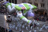 A Buzz Lightyear float makes it's way down 6th Ave. during the 87th Macy's Thanksgiving day parade in New York November 28, 2013. REUTERS/Carlo Allegri (UNITED STATES - Tags: ENTERTAINMENT BUSINESS SOCIETY)