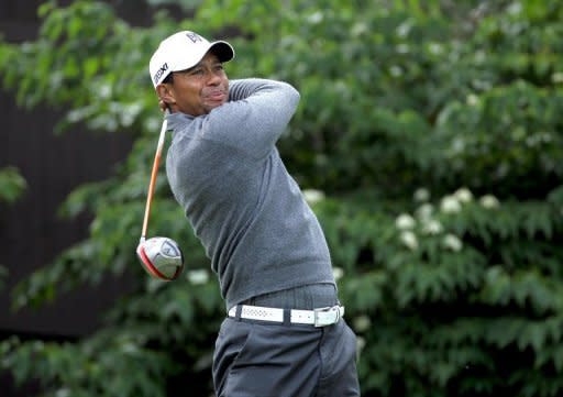 Tiger Woods hits his tee shot on the 13th hole at Muirfield Village Golf Club in Dublin, Ohio. Woods is alone in fourth after a one-over 73 for 212