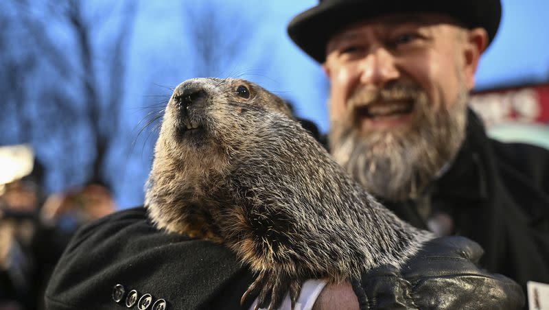 Groundhog Club handler A.J. Dereume holds Punxsutawney Phil, the weather prognosticating groundhog, during the 138th celebration of Groundhog Day on Gobbler’s Knob in Punxsutawney, Pa., on Friday, Feb. 2, 2024. Phil’s handlers said that the groundhog has forecast an early spring.
