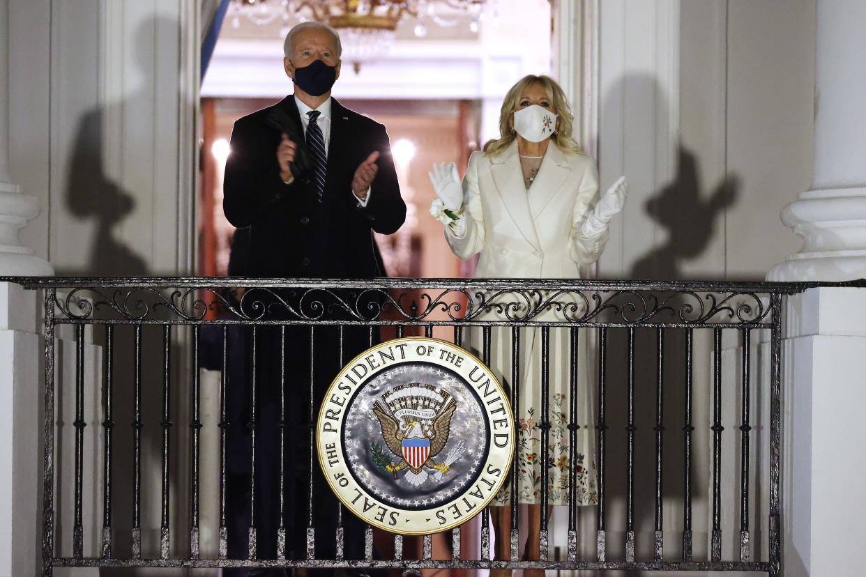 President Joe Biden and first lady Jill Biden watch a fireworks show on the National Mall from the Truman Balcony at the White House.