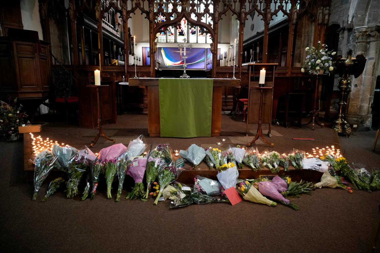 Flowers and candles lie at the altar (Getty Images)
