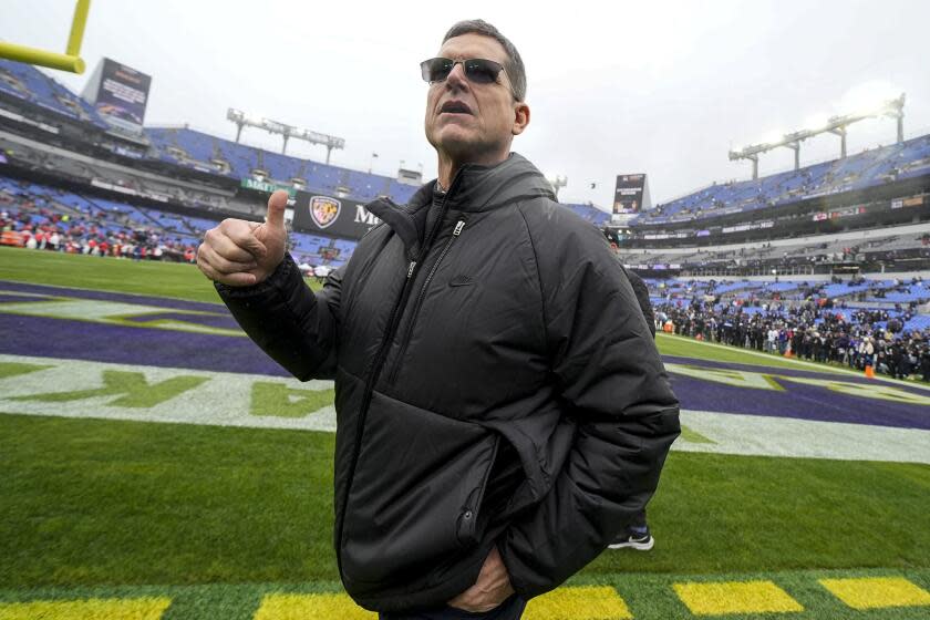 Los Angeles Chargers new head coach Jim Harbaugh walks on the field before an AFC Championship NFL football game