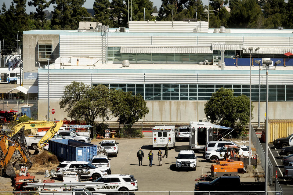 FILE - Law enforcement officers respond to the scene of a shooting at a Santa Clara Valley Transportation Authority (VTA) facility on May 26, 2021, in San Jose, Calif. One year after a problem employee shot and killed nine coworkers in a rampage at a light rail yard, the family of one of the victims filed a lawsuit, Thursday, May 26, 2022, alleging negligence and wrongful death by the Northern California transportation agency, the Santa Clara County Sheriff's Office and a private security firm by failing to address the gunman's history of violent threats and concerns raised by employees about him. (AP Photo/Noah Berger, File)