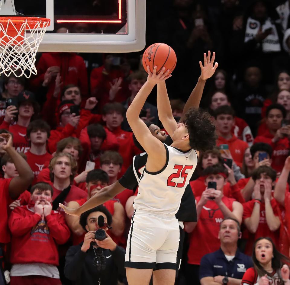 Lutheran West forward Joshua Meyer fails to beat the final buzzer as Buchtel guard Stevie Diamond defends in the final moments of the Division II state championship, Sunday, March 19, 2023, in Dayton. The backboard light is on signaling the end of the game with the ball still in Meyer's hands.