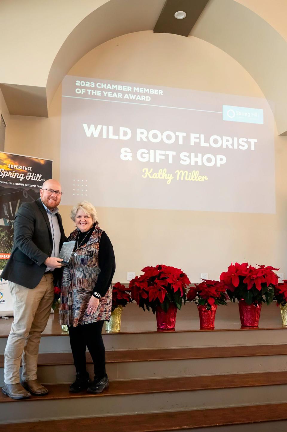 2023 Board Chair Jeff Graves presents Kathy Miller of Wild Root Florist & Gift Shop with the Spring Hill Chamber 2023 Chamber Member of the Year Award at the Annual State of the Chamber and Awards Ceremony on Dec. 7, 2023.