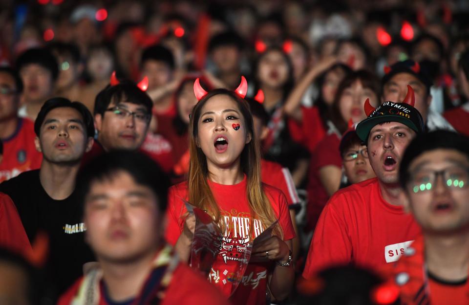 <p>South Korean football fans watch on a large screen during a street cheering event for their team’s 2018 World Cup match against Sweden at Gwanghwamun square in Seoul on June 18, 2018. (Photo by Jung Yeon-je / AFP) </p>