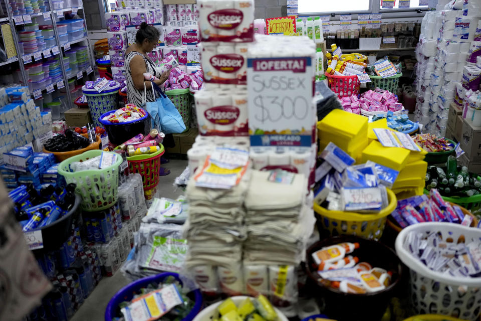 A woman shops at a market subsidized by the municipality so that residents can buy at lower prices amid rising inflation, in Lomas de Zamora, Argentina, Thursday, March 16, 2023. (AP Photo/Natacha Pisarenko)