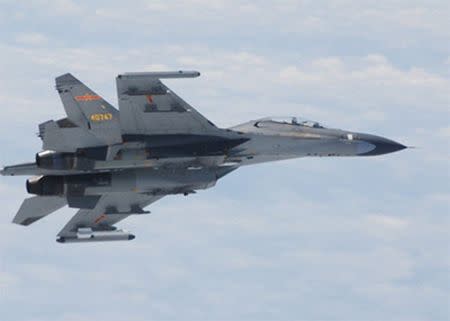 A Chinese SU-27 fighter jet flies over the East China Sea, in this handout photo taken June 11, 2014 and released by the Defense Ministry of Japan June 11, 2014. REUTERS/Defense Ministry of Japan/Handout via Reuters