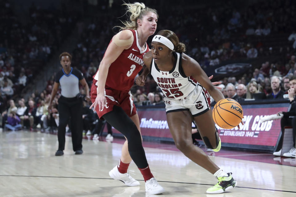 South Carolina guard Raven Johnson (25) drives to the basket past Alabama guard Sarah Ashlee Barker (3) during the first half of an NCAA college basketball game Thursday, Feb. 22, 2024, in Columbia, S.C. (AP Photo/Artie Walker Jr.)