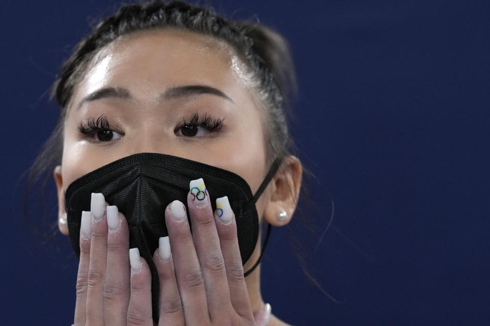 Sunisa Lee, of the United States, looks at the scoreboard for the final results of the artistic gymnastics women's all-around final at the 2020 Summer Olympics, Thursday, July 29, 2021, in Tokyo. (AP Photo/Gregory Bull)