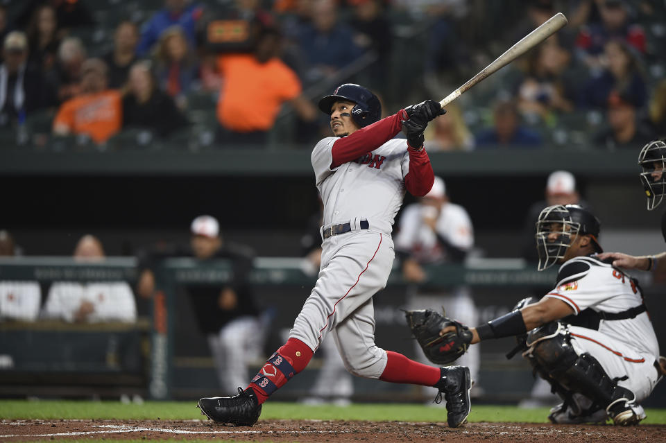 Boston Red Sox's Mookie Betts follows through on a solo home run against the Baltimore Orioles during the third inning of a baseball game Wednesday, May 8, 2019, in Baltimore. (AP Photo/Gail Burton)