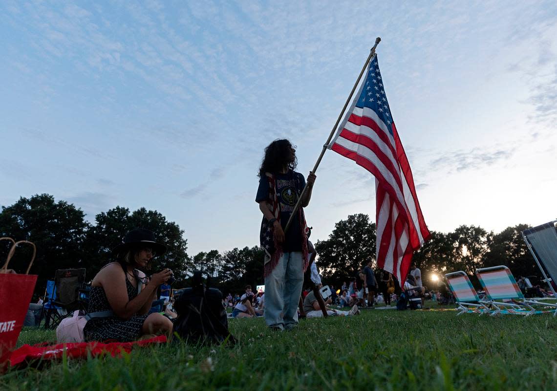 Ricardo Gomez-Alejo holds an American flag during an Independence Day celebration at Dorothea Dix Park on Tuesday, July 4, 2023, in Raleigh, N.C. Kaitlin McKeown/kmckeown@newsobserver.com