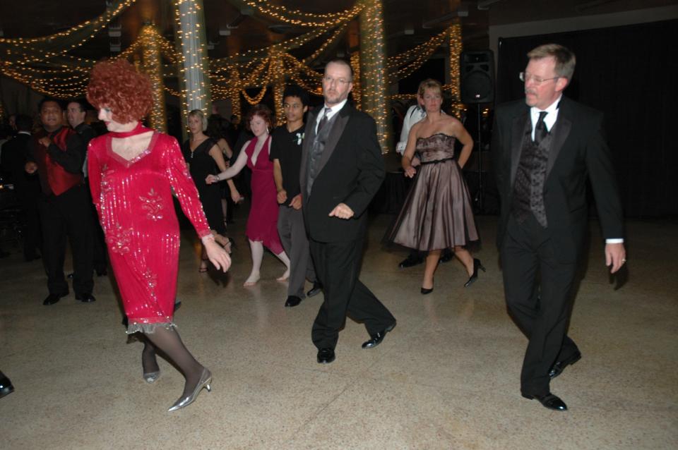 Attendees line dance during the third annual Black Tie Affair, themed "Copacabana," in the Newberry's Building on Saturday, Nov. 12, 2005. The fundraiser dinner raised $16,000 for AIDS Project of the Ozarks, The GLO Center, PROMO and the now defunct FOCUS group.