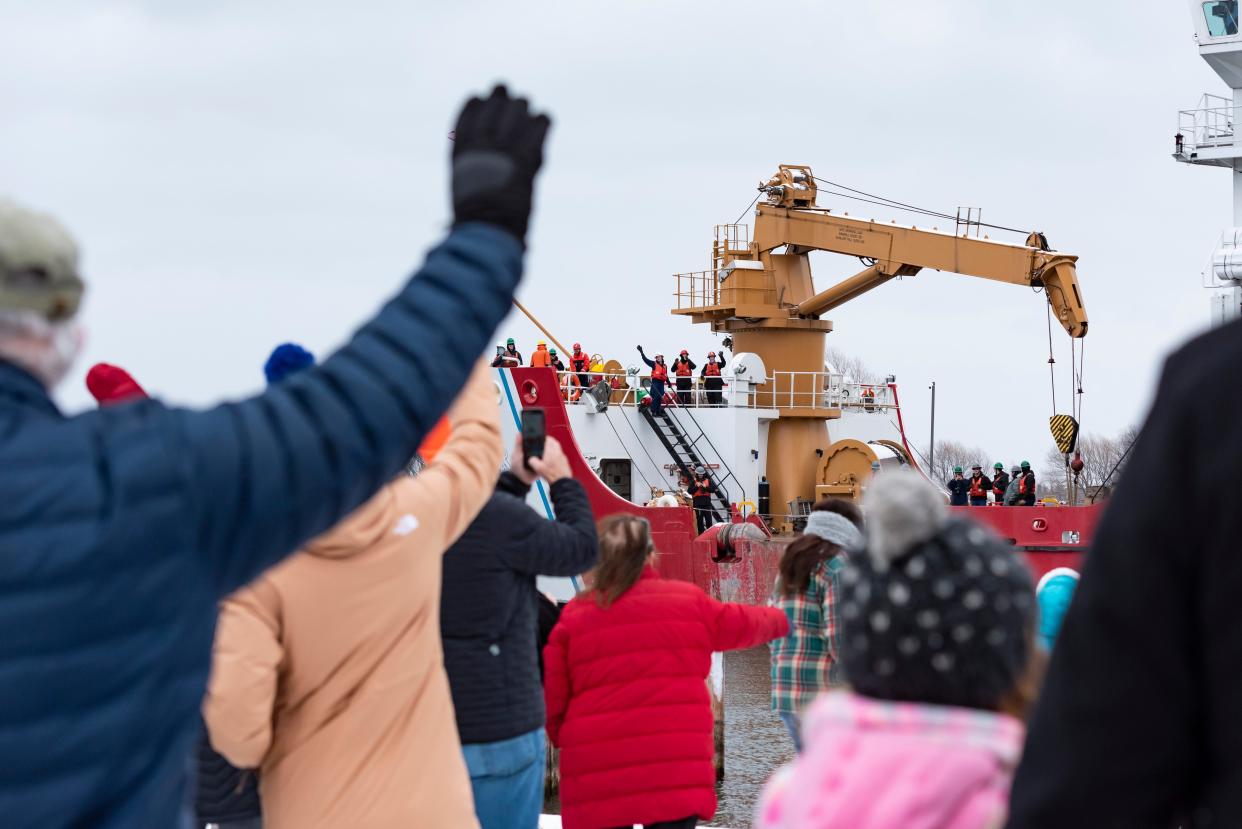 Community members wave to the crew aboard the U.S. Coast Guard Cutter Mackinaw during a send-off party held at the Cheboygan County Marina on Sunday, Nov. 26, 2023. The ship and crew were destined for Chicago with 1,200 Christmas trees aboard.