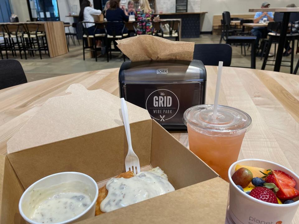 A half order of biscuits and gravy, strawberry lemonade and a fruit cup on opening day of Mama's Boy restaurant at the Wire Park development in Watkinsville, Ga. on Wednesday, Sept. 20, 2023.