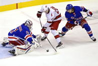 New York Rangers' goaltender Igor Shesterkin (31) stops Carolina Hurricanes' Sebastian Aho (20) as Rangers' Artemi Panarin (10) defends during second period NHL Eastern Conference Stanley Cup playoff action in Toronto on Tuesday, Aug. 4, 2020. (Frank Gunn/The Canadian Press via AP)