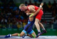 <p>Shinobu Ota of Japan (blue) competes against Stig-Andre Berge of Norway during the Men’s 59 kg Greco-Roman Wrestling quarterfinals on Day 9 of the Rio 2016 Olympic Games at the Carioca Arena 2 on August 15, 2016 in Rio de Janeiro, Brazil. (Photo by Phil Walter/Getty Images) </p>