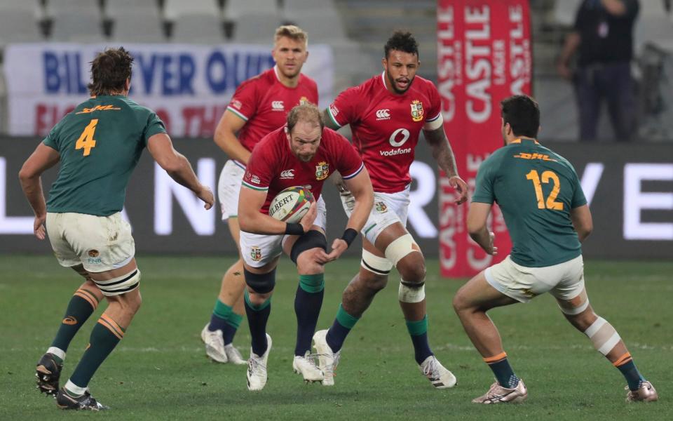 British and Irish Lions' Alun Wyn Jones, centre is tackled by South Africa's Eben Etzebeth , left and South Africa's Damian de Allende during the first rugby union test between South Africa's Springboks and the British and Irish Lions at the Cape Town Stadium, in Cape Town, South Africa, Saturday, July 31, 2021. - AP