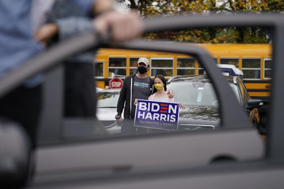 People listen during a campaign stop for Democratic presidential candidate former Vice President Joe Biden at Bucks County Community College, Saturday, Oct. 24, 2020, in Bristol, Pa. (AP Photo/Andrew Harnik)