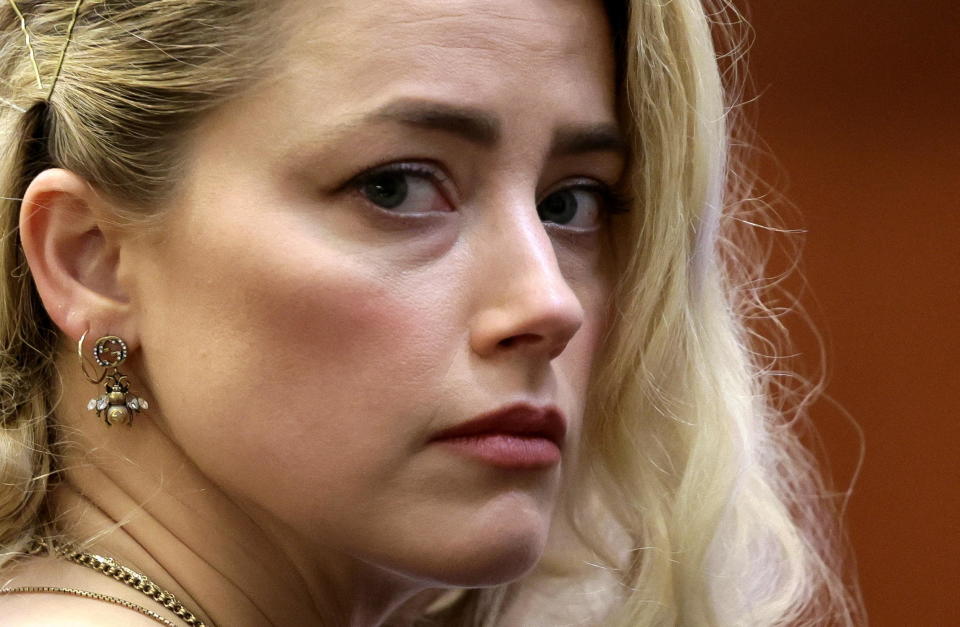 Actor Amber Heard waits before the jury said that they believe she defamed ex-husband Johnny Depp while announcing split verdicts in favor of both her ex-husband Johnny Depp and Heard on their claim and counter-claim in the Depp v. Heard civil defamation trial at the Fairfax County Circuit Courthouse in Fairfax, Virginia, U.S., June 1, 2022. / Credit: Evelyn Hockstein / REUTERS
