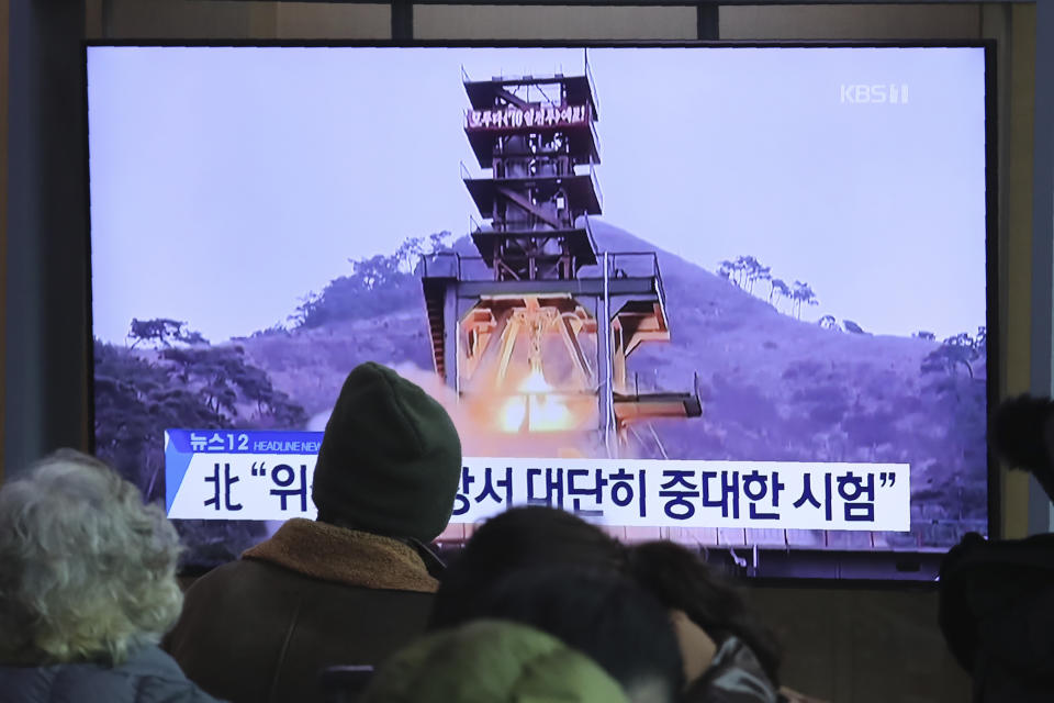 People watch a TV screen showing a file image of a ground test of North Korea's rocket engine during a news program at the Seoul Railway Station in Seoul, South Korea, Monday, Dec. 9, 2019. North Korea said Sunday it carried out a "very important test" at its long-range rocket launch site that it reportedly rebuilt after having partially dismantled it after entering denuclearization talks with the United States last year. The sign reads: "Very important test." (AP Photo/Ahn Young-joon)