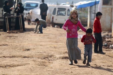 Children walk outside tents tents housing internally displaced people in Atma camp, near the Syrian-Turkish border in Idlib Governorate, February 5, 2016. REUTERS/Ammar Abdullah