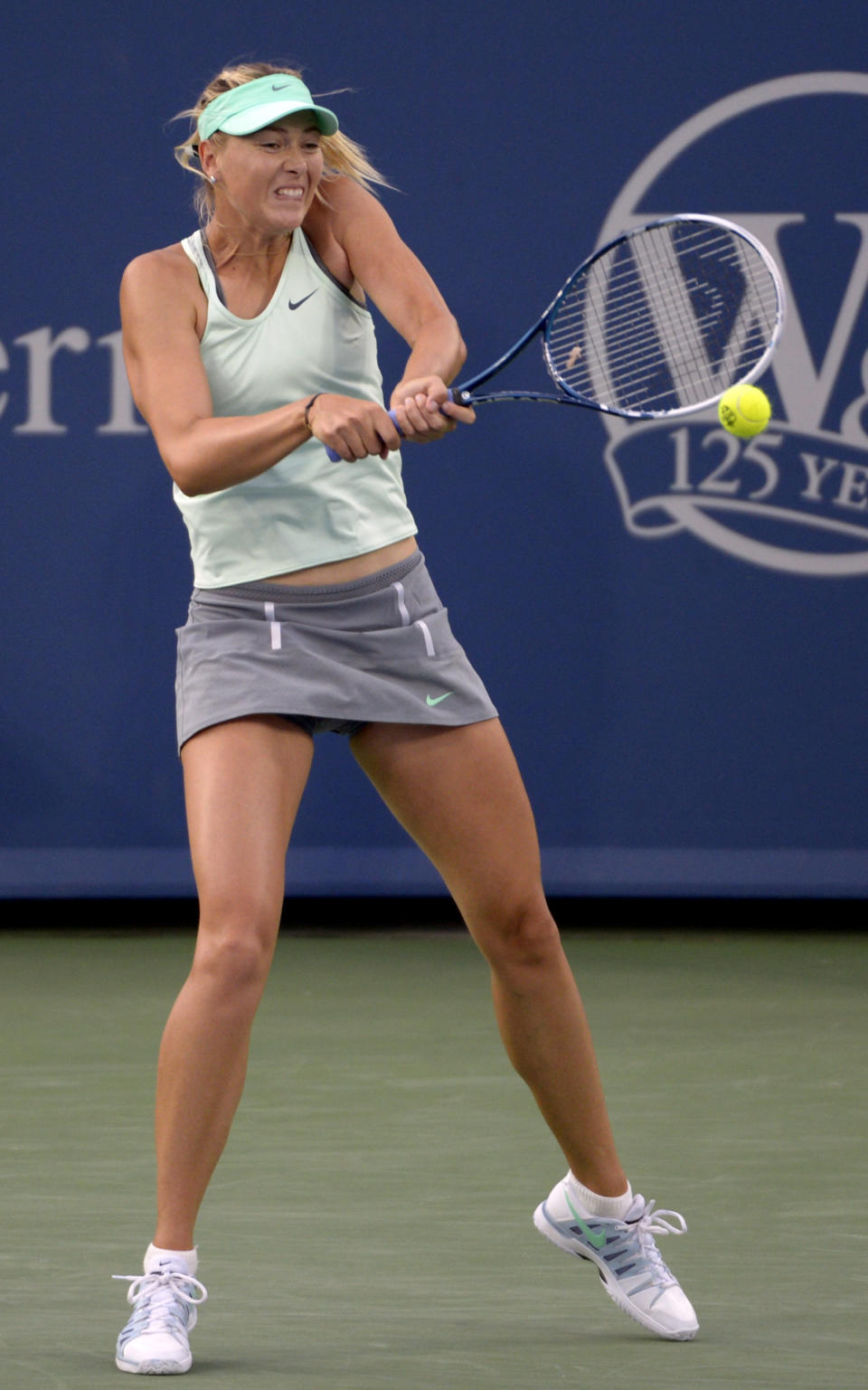 Maria Sharapova, from Russia, hits a return during a match against Sloane Stephens, from the United States, at the Western & Southern Open tennis tournament, Tuesday, August 13, 2013, in Mason, Ohio. (AP Photo/Michael E. Keating)