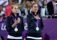 LONDON, ENGLAND - AUGUST 08: Silver medallists Jennifer Kessy (L) and April Ross of the United States celebrate on the podium during the medal ceremony for the Women's Beach Volleyball on Day 12 of the London 2012 Olympic Games at the Horse Guard's Parade on August 8, 2012 in London, England. (Photo by Cameron Spencer/Getty Images)