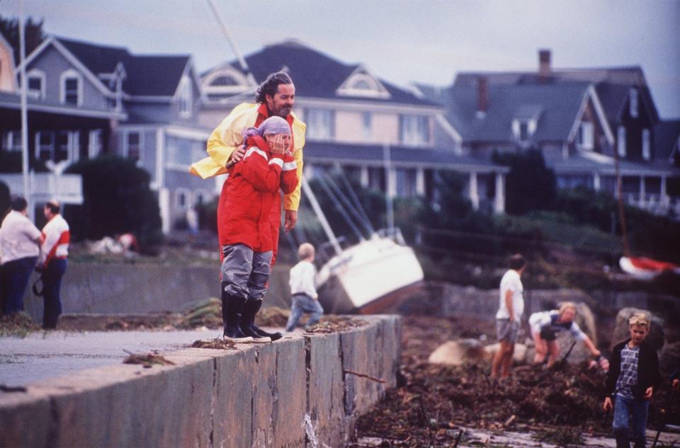 Clyde Herlitz and Carolyn Gassmann, both of Bourne, console each other after finding their boat off of Monument Beach after Hurricane Bob hit the Cape in August of 1991.