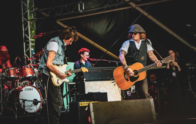 Jeff Beck and Johnny Depp performing on stage