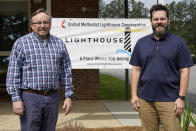 The Rev. Ed McKinney, pastor of Stokesdale United Methodist Church, left, and Michael Hahn, right, pose for a photo near a welcoming sign at the church in Stokesdale, N.C., Monday, May 15, 2023. Some United Methodist regional conferences have begun designating “Lighthouse” congregations – ones that actively welcome people who wanted to stay United Methodist but whose former churches voted to leave. Other conferences use different names, such as “Beacon” or “Oasis,” but the idea is the same. (AP Photo/Chuck Burton)