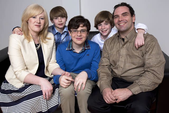 <p>Shutterstock</p> Kristine and Michael Barnett pose with their sons in 2012