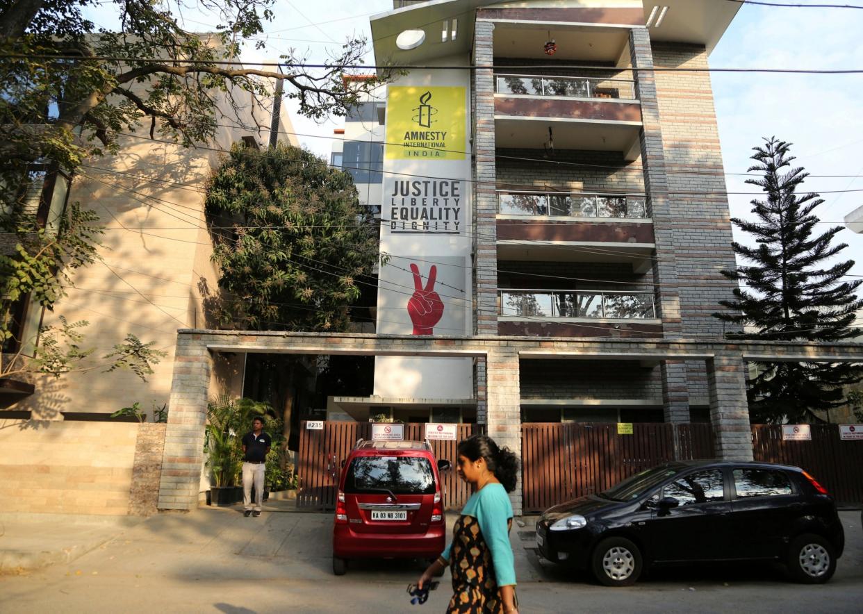 A woman walks past the Amnesty International India headquarters in Bangalore, India: AP