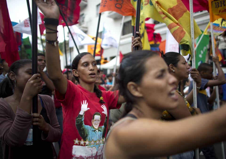 Government supporters march during an anti-imperialist rally in Caracas, Venezuela, Saturday, March 30, 2019. Venezuelan opposition leader Juan Guaido took his campaign for change to one of the country's most populous states on Saturday, while supporters of the man he is trying to oust, President Nicolas Maduro, held a rival demonstration in the capital after another nationwide blackout. (AP Photo/Ariana Cubillos)