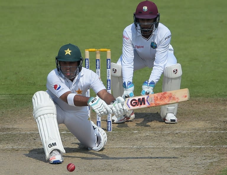 Pakistan batsman Sami Aslam (L) plays a shot a West Indies' wicketkeeper Shane Dowrich looks on during the first day of the third Test at the Sharjah Cricket Stadium in Sharjah on October 30, 2016