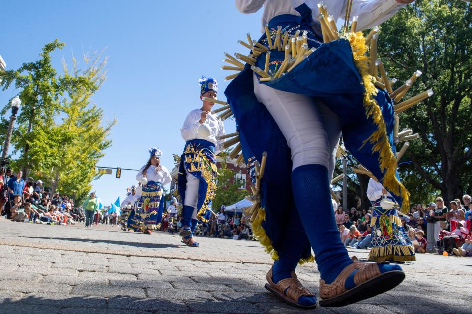 Participants in the Mexican delegation, who are members of St. Mary’s Catholic Church, wear traditional outfits and perform a dance to venerate the Virgin Mary, as part of the Parade of Cultures during the International Food and Art Festival on Saturday, October 1, 2022, in Jackson, Tenn. 