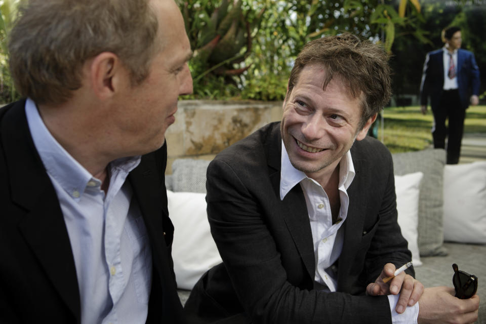 In this photo taken Sunday, May 19, 2013, actor Mathieu Amalric, right, and director Arnaud Desplechin pose for photographs following an interview with The Associated Press at the 66th international film festival, in Cannes, southern France. Amalric depicts a maverick academic counseling Benicio Del Toro's Native American war vet in "Jimmy P.: Psychotherapy of a Plains Indian," director Arnaud Desplechin's Cannes Film Festival contender. (AP Photo/David Azia)